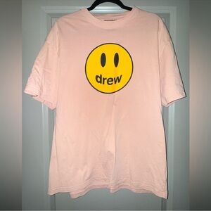 drew house pink tee with yellow smiley logo